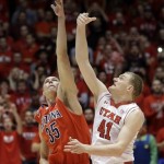 Arizona's Kaleb Tarczewski (35) and Utah's Jeremy Olsen (41) go for the ball during the tip off in the first half of an NCAA college basketball game, Wednesday, Feb. 19, 2014, in Salt Lake City. (AP Photo/Rick Bowmer)
