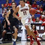 Arizona's Aaron Gordon (11) dribbles the ball away from Fairleigh Dickinson's Matt MacDonald (3) in the first half of an college NCAA basketball game, Monday, Nov. 18, 2013 in Tucson, Ariz. This is in the first round of the NIT. (AP Photo/John Miller)
