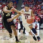 Arizona's Nick Johnson (13) dribbles around Colorado's Spencer Dinwiddie (25) during the second half of an NCAA college basketball game at McKale Center in Tucson, Ariz., Thursday, Jan. 3, 2013. Arizona won 92-83 in overtime. (AP Photo/Wily Low)