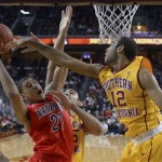 Arizona forward Brandon Ashley, left, puts up a shot as Southern California center Omar Oraby, center, and guard Julian Jacobs defend during the second half of an NCAA college basketball game, Sunday, Jan. 12, 2014, in Los Angeles. (AP Photo/Mark J. Terrill)