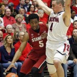 Stanford's Chasson Randle (5) works around Arizona's T.J. McConnell (4) during the first half of an NCAA college basketball game Sunday, March 2, 2014, in Tucson, Ariz. (AP Photo/John MIller)