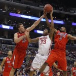 Ohio State's Amir Williams, center, tries to shoot between Arizona defenders Kaleb Tarczewski, left, and Kevin Parrom during the first half of a West Regional semifinal in the NCAA men's college basketball tournament, Thursday, March 28, 2013, in Los Angeles. (AP Photo/Jae C. Hong)