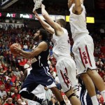 Northern Arizona's Gaellan Bewernick, left, tries to shoot over Arizona's Kaleb Tarczewshi, center, and Solomon Hill, right, during the first half of an NCAA college basketball game at McKale Center in Tucson, Ariz., Wednesday, Nov. 28, 2012. (AP Photo/Wily Low)