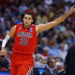 Arizona's Grant Jerrett celebrates following a basket against Ohio State during the first half of a West Regional semifinal in the NCAA men's college basketball tournament, Thursday, March 28, 2013, in Los Angeles. (AP Photo/Jae C. Hong)
