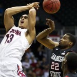 Arizona guard Nick Johnson (13) has the basketball stripped away from behind by San Diego State guard Chase Tapley (22) in the first half of an NCAA college basketball game at the Diamond Head Classic, Tuesday, Dec. 25, 2012, in Honolulu. (AP Photo/Eugene Tanner)