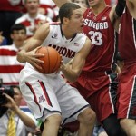 Arizona's Aaron Gordon, left, looks to pass the ball against the defense of Stanford's Dwight Powell (33 ) and Stefan Nastic, far right, in the first half of an NCAA college basketball game, Sunday, March 2, 2014 in Tucson, Ariz. (AP Photo/John MIller)