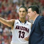 Arizona's head coach Sean Miller, right, talks with Nick Johnson (13) during the second half of an NCAA college basketball game against Southern California at McKale Center in Tucson, Ariz., Saturday, Jan. 26, 2013. (AP Photo/Wily Low)
