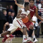  Arizona's Trey Mason, in front, dribbles around the defense of Washington States' Will Dilorio, in back, in the second half of an NCAA college basketball game on Thursday, Jan. 2, 2014 in Tucson, Ariz. Arizona won 60 - 25. (AP Photo/John MIller)