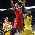 Arizona's Solomon Hill (44) drives between Oregon's E.J. Singler, left, and Tony Woods (55) during the second half of their NCAA college basketball game, Thursday, Jan. 10, 2013, in Eugene, Ore. Oregon won 70-66. (AP Photo/Chris Pietsch)
