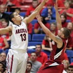 Arizona's Nick Johnson (13) blocks a shot by Stanford's Aaron Bright, right, during the first half of an NCAA college basketball game at McKale Center in Tucson, Ariz.,Wednesday, Feb. 6, 2013. (AP Photo/John Miller)