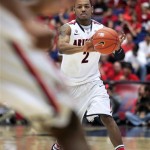 Arizona's Mark Lyon (2) passes the ball during the first half against Washington State in an NCAA college basketball game at McKale Center in Tucson, Ariz., Saturday, Feb. 23, 2013. (AP Photo/John Miller)
