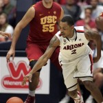 Arizona's Mark Lyons (2) struggles with the ball in front of Southern California's Omar Oraby (55) during the second half of an NCAA basketball game at McKale Center in Tucson, Ariz., Saturday, Jan. 26, 2013. (AP Photo/John Miller)
