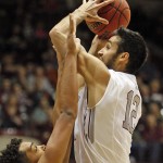 Montana forward Martin Breunig (12) shoots against Northern Arizona forward Jordyn Martin (34) during the first half of an NCAA college basketball game in the semifinals of the Big Sky tournament in Missoula, Mont., on Friday, March 13, 2015. (AP Photo/Michael Albans)
