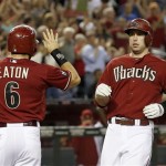 Arizona Diamondbacks' Paul Goldschmidt, right, gets ready for a high-five from teammate Adam Eaton (6) after hitting a two-run home run against the Los Angeles Dodgers in the first inning during a baseball game on Wednesday, Sept. 18, 2013, in Phoenix. (AP Photo/Ross D. Franklin)
