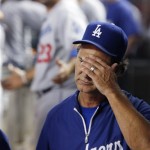 Los Angeles Dodgers manager Don Mattingly, right, covers his face after Adrian Gonzalez (23) is ejected for arguing a call in the sixth inning during a baseball game against the Arizona Diamondbacks on Wednesday, Sept. 18, 2013, in Phoenix. (AP Photo/Ross D. Franklin)
