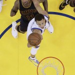 
              Golden State Warriors guard Stephen Curry, bottom, shoots in front of Cleveland Cavaliers center Tristan Thompson (13) during the second half of Game 2 of basketball's NBA Finals in Oakland, Calif., Sunday, June 7, 2015. The Cavaliers won 95-93 in overtime. (AP Photo/Jeff Chiu, Pool)
            