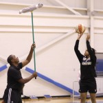 
              In this July 14, 2015, photo, New York Liberty President IsiahThomas, left, holds up a broom to help Brittany Boyd work on shooting over defenders after a team practice in Greenburgh, N.Y. The chance to work with the Liberty is a turnaround of sorts for Thomas, too. His last stint in New York ended poorly. (AP Photo/Seth Wenig)
            