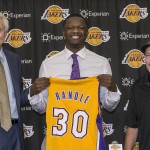 
              FILE - In this June 30, 2014, file photo, Los Angeles Lakers general manager Mitch Kupchak, left, and Jim Buss, right, part-owner and executive vice president of basketball operations, introduce forward Julius Randle during an NBA basketball news conference in El Segundo, Calif. The former Kentucky forward was selected seventh overall by the Lakers in the 2014 NBA draft. If history is any guide, the Lakers are about to get a great player with the No. 2 pick in the draft. The Lakers have had only five top-two picks before, and four of them turned out to be Hall of Famers. The fifth? He was traded for Kareem Abdul-Jabbar. (AP Photo/Damian Dovarganes, File)
            