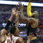 
              Cleveland Cavaliers forward LeBron James, right, shoots over Chicago Bulls forward Taj Gibson, left, and guard Jimmy Butler during the first half of Game 4 in a second-round NBA basketball playoff series in Chicago on Sunday, May 10, 2015. (AP Photo/Nam Y. Huh)
            