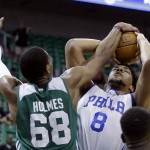 
              Boston Celtics' Jonathan Holmes (68) defends against Philadelphia 76ers' Jahlil Okafor (8) during the first half of an NBA summer league basketball game Tuesday, July 7, 2015, in Salt Lake City. (AP Photo/Rick Bowmer)
            