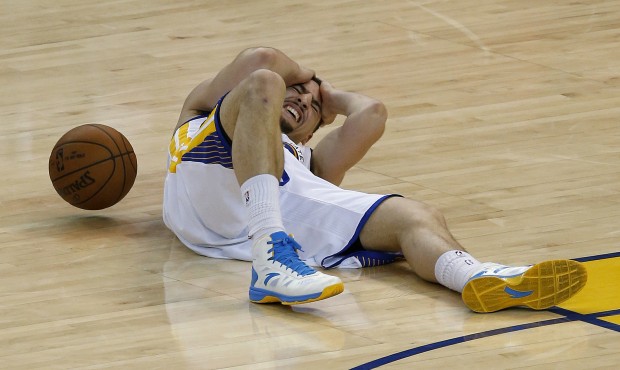 Golden State Warriors guard Klay Thompson lies on the court after being injured during the second h...