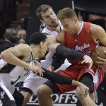 
              Los Angeles Clippers' Blake Griffin, right, is pressured by San Antonio Spurs' Danny Green (14) and Tiago Splitter, center, during the second half of Game 3 in an NBA basketball first-round playoff series, Friday, April 24, 2015, in San Antonio. (AP Photo/Darren Abate)
            