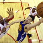 
              Golden State Warriors guard Klay Thompson (11) shoots as Houston Rockets center Dwight Howard, left, defends during the second half in Game 3 of the NBA basketball Western Conference finals Saturday, May 23, 2015, in Houston. (AP Photo/David J. Phillip, Pool)
            