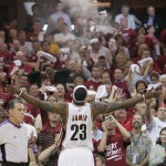 
              FILE - In this May 29, 2007, file photo, Cleveland Cavaliers forward LeBron Jame throws talc on front of Cavs fans during game 4 of the NBA Eastern Conference Finals in Cleveland. For athletes across all sports, it's become a way of life as the primary focus has shifted from fans watching in person to fans at home and in the sports bars watching on television. The camera is always watching, there are few places to hide and they have come to accept them as a part of their world from the moment they arrive for work.  (AP Photo/Mark Duncan, File)
            