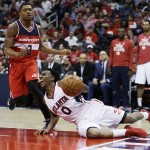 
              Atlanta Hawks' Jeff Teague, right, falls to the floor while dribbling in front of Washington Wizards' Bradley Beal in the first quarter of Game 5 of the second round of the NBA basketball playoffs Wednesday, May 13, 2015, in Atlanta. (AP Photo/John Bazemore)
            