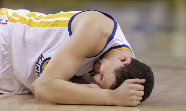 In this photo taken May 27, 2015, Golden State Warriors guard Klay Thompson reacts after taking a k...