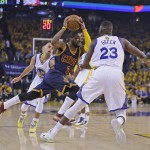 
              Cleveland Cavaliers guard Kyrie Irving (2) drives between Golden State Warriors forward Draymond Green (23) and guard Stephen Curry during the first half of an Game 1 of basketball's NBA Finals in Oakland, Calif., Thursday, June 4, 2015. (AP Photo/Ben Margot)
            
