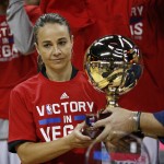 
              San Antonio Spurs coach Becky Hammon holds up the championship trophy after they defeated the Phoenix Suns in an NBA summer league championship basketball game Monday, July 20, 2015, in Las Vegas. (AP Photo/John Locher)
            