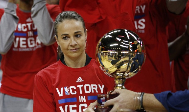 San Antonio Spurs coach Becky Hammon holds up the championship trophy after they defeated the Phoen...