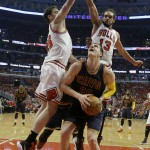 
              Cleveland Cavaliers center Timofey Mozgov, bottom, looks to the basket as Chicago Bulls forward Pau Gasol, left, and center Joakim Noah guard during the first half of Game 3 in a second-round NBA basketball playoff series in Chicago on Friday, May 8, 2015. (AP Photo/Nam Y. Huh)
            
