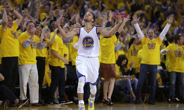Fans cheer as Golden State Warriors guard Stephen Curry (30) reacts after scoring during the first ...
