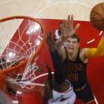 
              Cleveland Cavaliers center Timofey Mozgov (20) shoots against Atlanta Hawks forward Paul Millsap (4) during the first half in Game 1 of the Eastern Conference finals of the NBA basketball playoffs, Wednesday, May 20, 2015, in Atlanta. (AP Photo/John Bazemore)
            