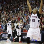 
              Atlanta Hawks' Kyle Korver, center, celebrates along with teammate Al Horford, right, as the Hawks beat the Washington Wizards 82-81 in Game 5 of the second round of the NBA basketball playoffs Wednesday, May 13, 2015, in Atlanta. (AP Photo/John Bazemore)
            