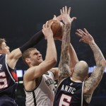 
              Atlanta Hawks' Kyle Korver (26) and Pero Antic (6) defend Brooklyn Nets' Brook Lopez during the first half of Game 6 in a first round NBA playoff basketball game Friday, May 1, 2015, in New York. (AP Photo/Frank Franklin II)
            