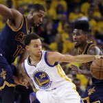 
              Golden State Warriors guard Stephen Curry (30) tries to control the ball as he is guarded by Cleveland Cavaliers center Tristan Thompson (13) and guard Iman Shumpert during the first half of Game 2 of basketball's NBA Finals in Oakland, Calif., Sunday, June 7, 2015. (AP Photo/Ben Margot)
            