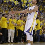 
              Fans cheer as Golden State Warriors guard Stephen Curry (30) reacts after scoring during the first half of Game 5 in a second-round NBA playoff basketball series against the Memphis Grizzlies in Oakland, Calif., Wednesday, May 13, 2015. (AP Photo/Ben Margot)
            