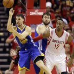 
              Golden State Warriors guard Klay Thompson (11) passes the ball as Houston Rockets center Dwight Howard (12) looks on during the second half in Game 4 of the NBA basketball Western Conference finals Monday, May 25, 2015, in Houston. (AP Photo/David J. Phillip)
            