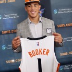               Phoenix Suns first-round draft pick and former Kentucky guard Devin Booker poses with a jersey as he is introduced during an NBA basketball news conference, Friday, June 26, 2015, in Phoenix. (AP Photo/Matt York)
            