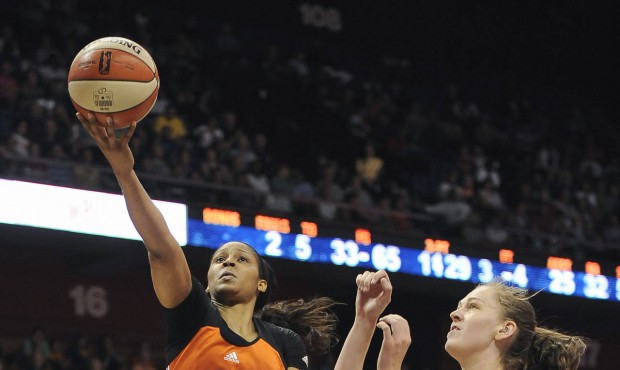 West’s Maya Moore, left, of the Minnesota Lynx, shoots as East’s Emma Meesseman, of the...