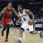 
              San Antonio Spurs' Kawhi Leonard (2) drives around Los Angeles Clippers' Matt Barnes (22) during the second half of Game 3 in an NBA basketball first-round playoff series, Friday, April 24, 2015, in San Antonio. (AP Photo/Darren Abate)
            