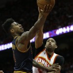 
              Cleveland Cavaliers guard Iman Shumpert (4) shoots against Atlanta Hawks center Al Horford (15) during the second half in Game 2 of the Eastern Conference finals of the NBA basketball playoffs, Friday, May 22, 2015, in Atlanta. (AP Photo/David Goldman)
            
