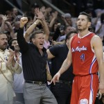 
              Los Angeles Clippers' J.J. Redick (4) walks past cheering San Antonio Spurs fans during the first half of Game 3 in an NBA basketball first-round playoff series, Friday, April 24, 2015, in San Antonio. (AP Photo/Darren Abate)
            