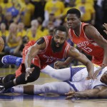 
              Houston Rockets guard James Harden (13) and center Clint Capela (15) try to get to a loose ball over Golden State Warriors center Festus Ezeli during the first half of Game 5 of the NBA basketball Western Conference finals in Oakland, Calif., Wednesday, May 27, 2015. (AP Photo/Ben Margot)
            