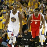 
              Golden State Warriors forward Draymond Green (23) reacts after scoring, in front of Houston Rockets center Clint Capela (15) during the first half of Game 1 of the NBA basketball Western Conference finals in Oakland, Calif., Tuesday, May 19, 2015. (AP Photo/Tony Avelar)
            