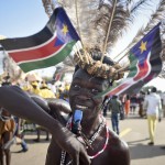 
              A South Sudanese man wears a headdress of feathers and the national flag, as he attends an independence day ceremony in the capital Juba, South Sudan, Thursday, July 9, 2015. South Sudan marked four years of independence from Sudan on Thursday, but the celebrations were tempered by concerns about ongoing violence and the threat of famine. (AP Photo/Jason Patinkin)
            