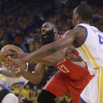 
              Houston Rockets guard James Harden (13) drives between Golden State Warriors forward Draymond Green, left, and forward Harrison Barnes during the first half of Game 5 of the NBA basketball Western Conference finals in Oakland, Calif., Wednesday, May 27, 2015. (AP Photo/Ben Margot)
            